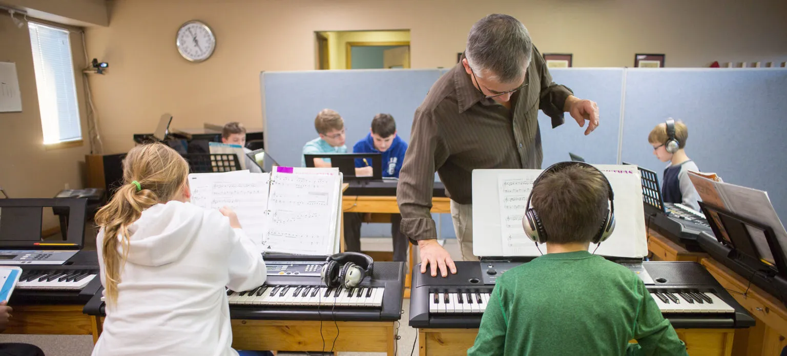 Eric leading a group piano lesson at Lawrence Piano Studio