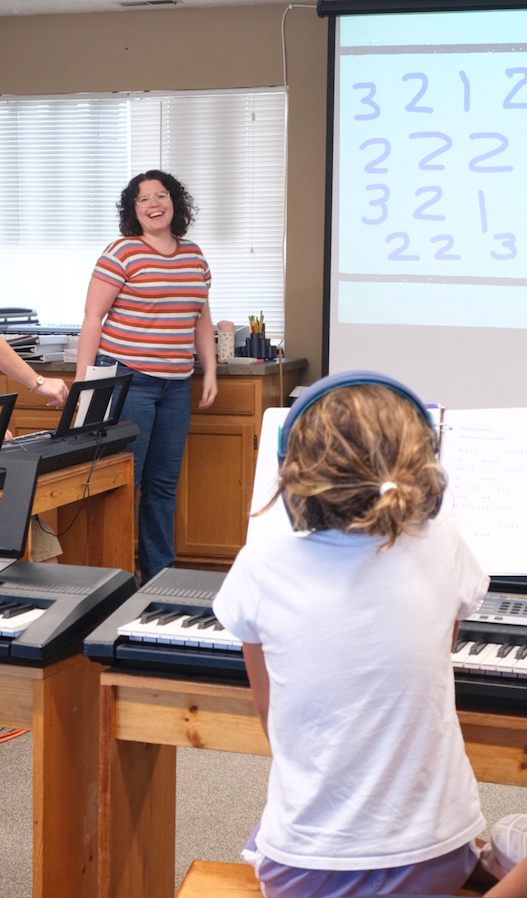 Gina leading a group piano lesson