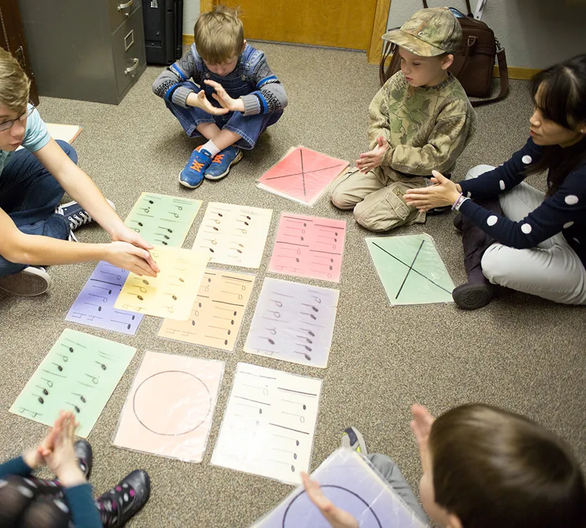 Students playing a rhythm game during group piano lesson
